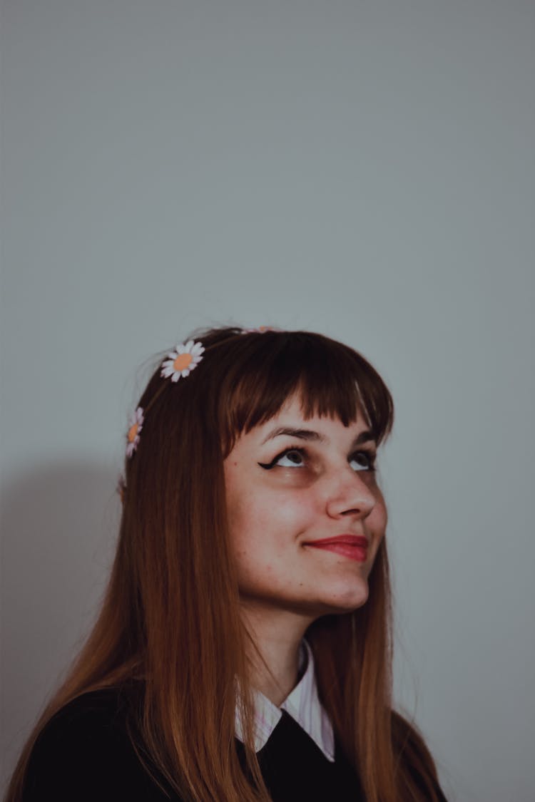 A Woman Wearing Floral Headband Looking Upwards