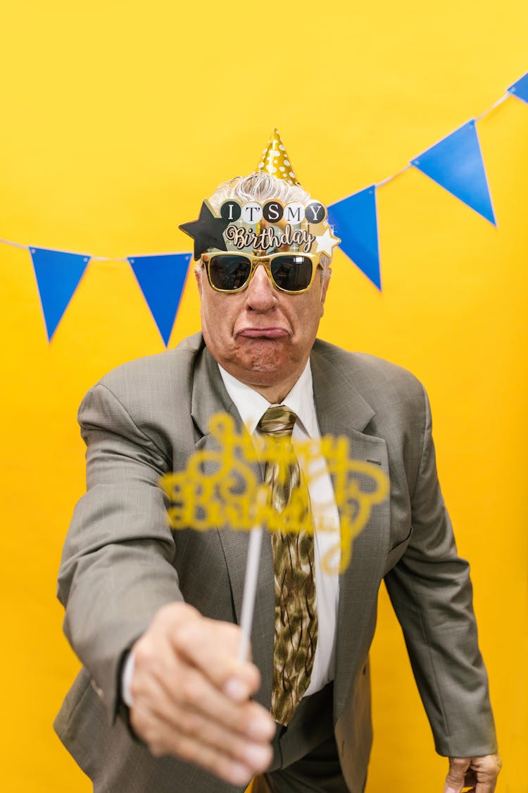 A Grumpy Man In Gray Suit Celebrating His Birthday