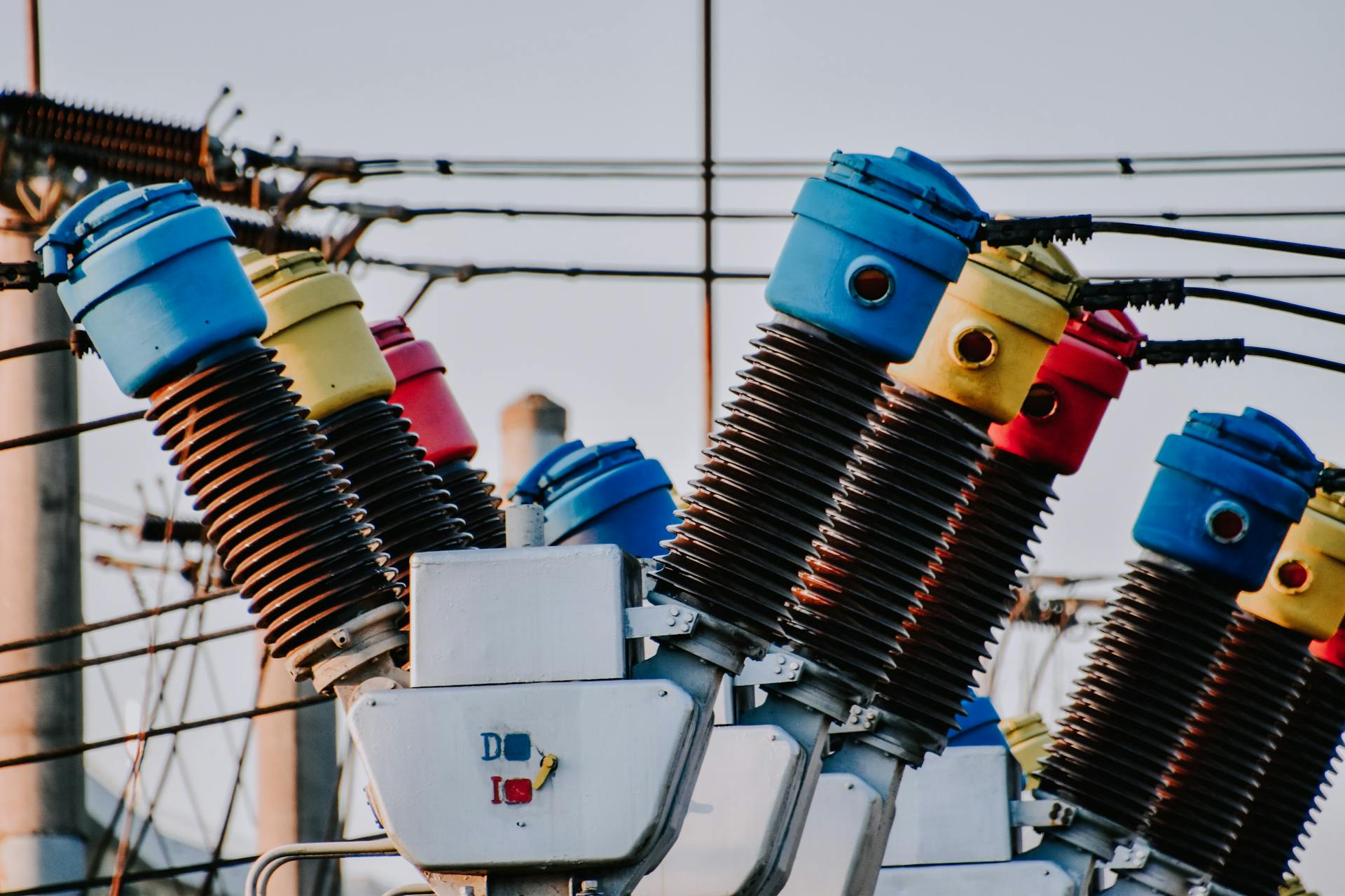 Colorful high voltage insulators in an electric substation highlighting power infrastructure.