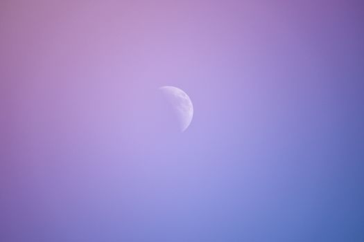A peaceful crescent moon set against a gradient twilight sky, capturing tranquility and beauty.