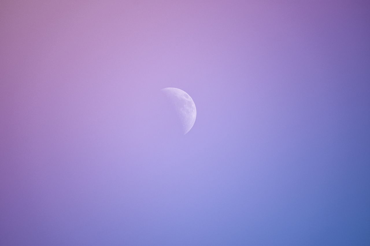 a peaceful crescent moon set against a gradient twilight sky capturing