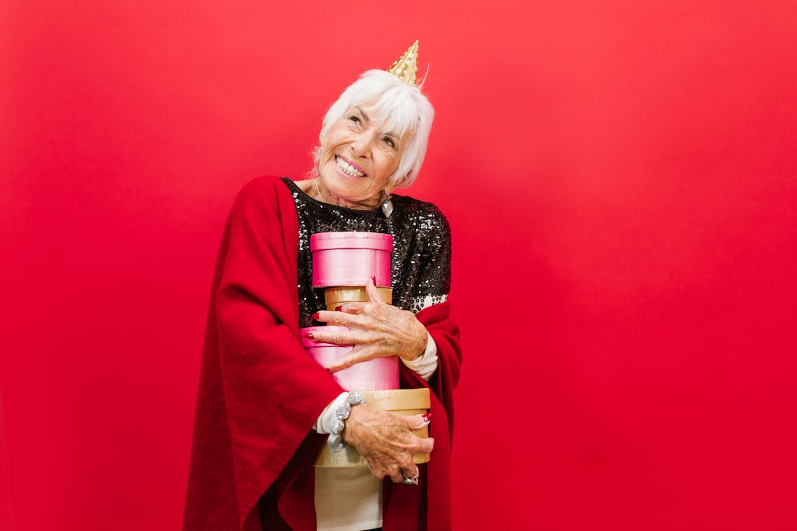 Elderly woman with gifts, Stock image