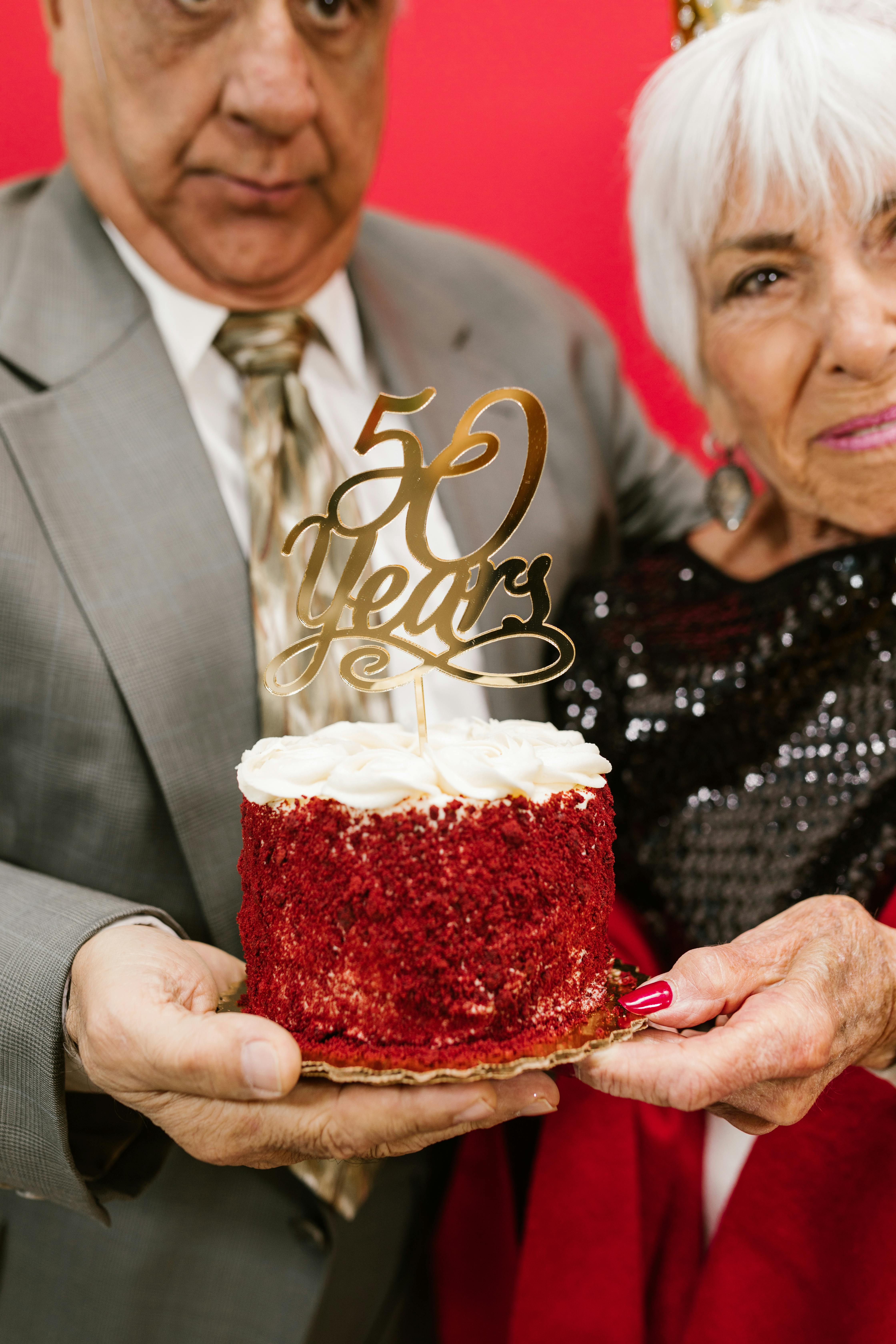 a man and woman holding a cake