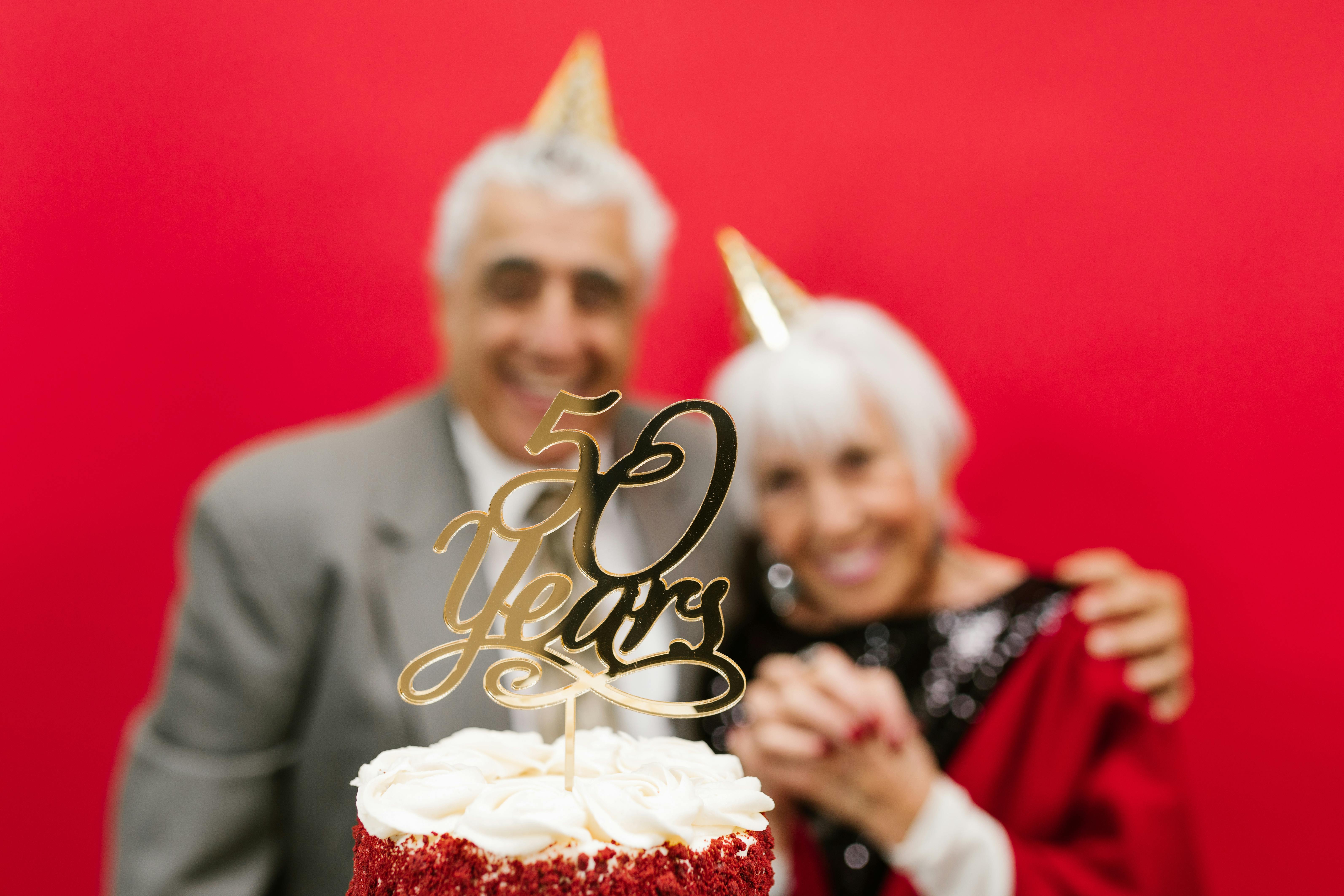 man and woman in behind a cake