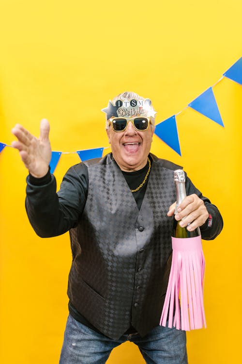 An Elderly Man Holding a Champagne Bottle