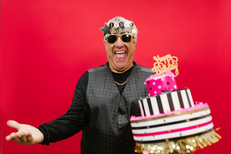 A Man Holding His Birthday Cake