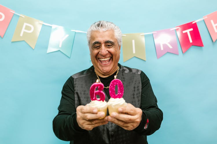 A Man Holding Cupcakes