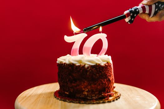 Hand Lighting Up Candle on Cake 