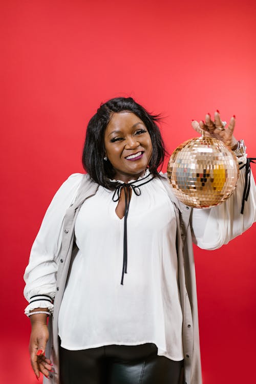 Woman in White Top Holding a Mirror Ball