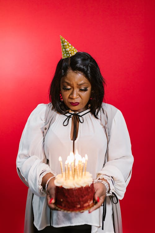 Free Woman in White Long Sleeve Shirt Holding a Cake Stock Photo