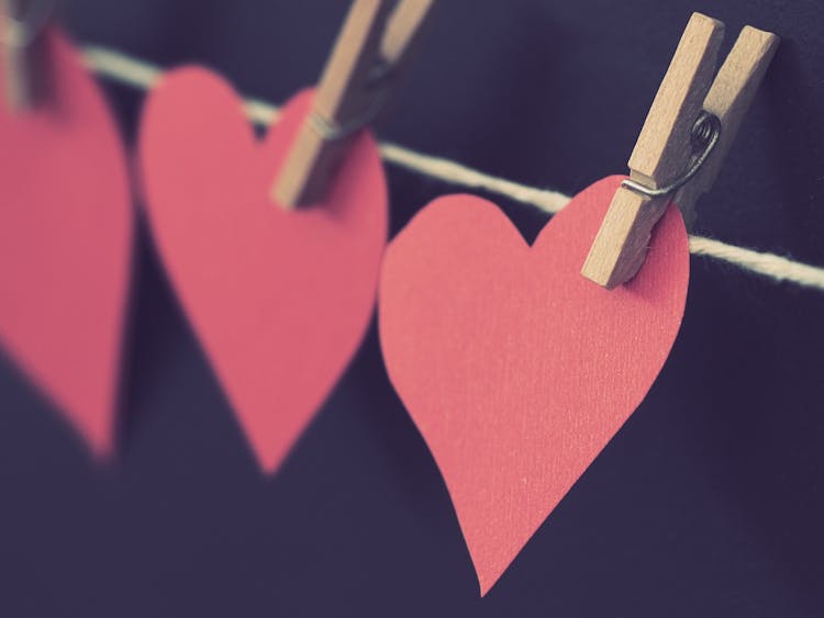 Photo Of Red Heart-shaped Paper Hanging On Rope