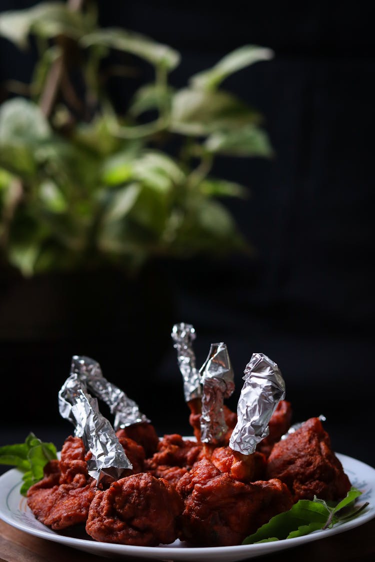 Chicken Lollipop With Aluminum Foil On Plate