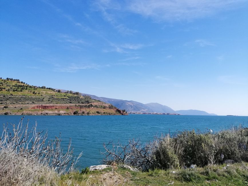 Breathtaking view of a Greek island coastline with clear blue waters and vibrant nature.
