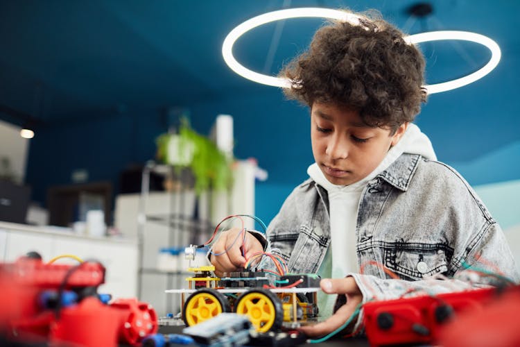 A Boy Holding A Toy Car