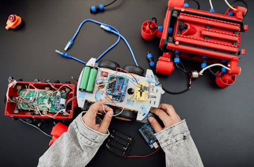 A Person Fixing a Toy Car