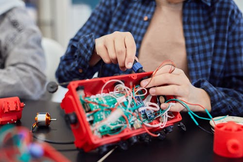 Free A Person Fixing Electronics Stock Photo