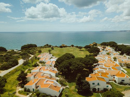Free Aerial view of Algarve's picturesque coastline and white houses with red roofs. Stock Photo