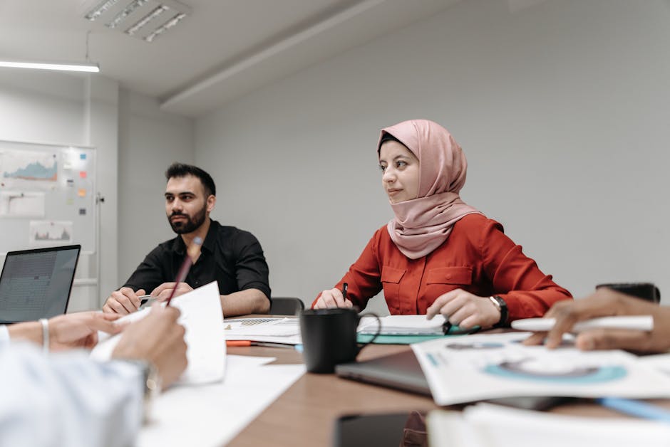 Image showing diverse professionals sharing their career experiences during a collaborative discussion in an office setting.. Pavel Danilyuk caught it perfectly