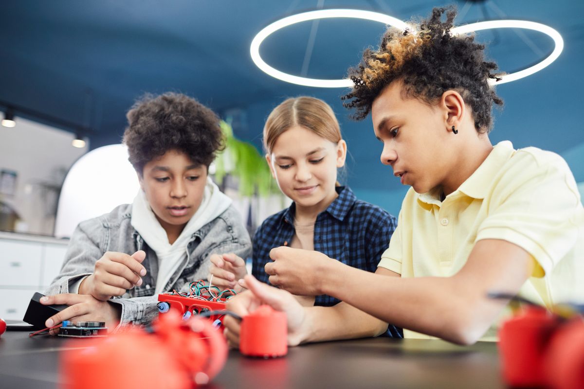 Teenagers collaborating on a robotics project