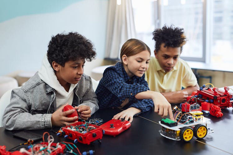 Children Playing With Toys And Learning Electronics