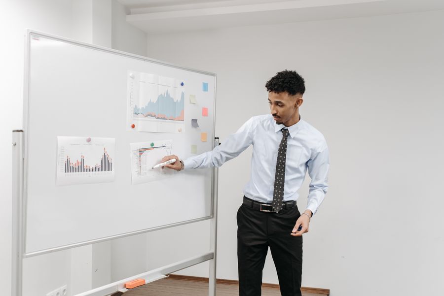 Presenter at a whiteboard — photo by Pavel Danilyuk on Pexels