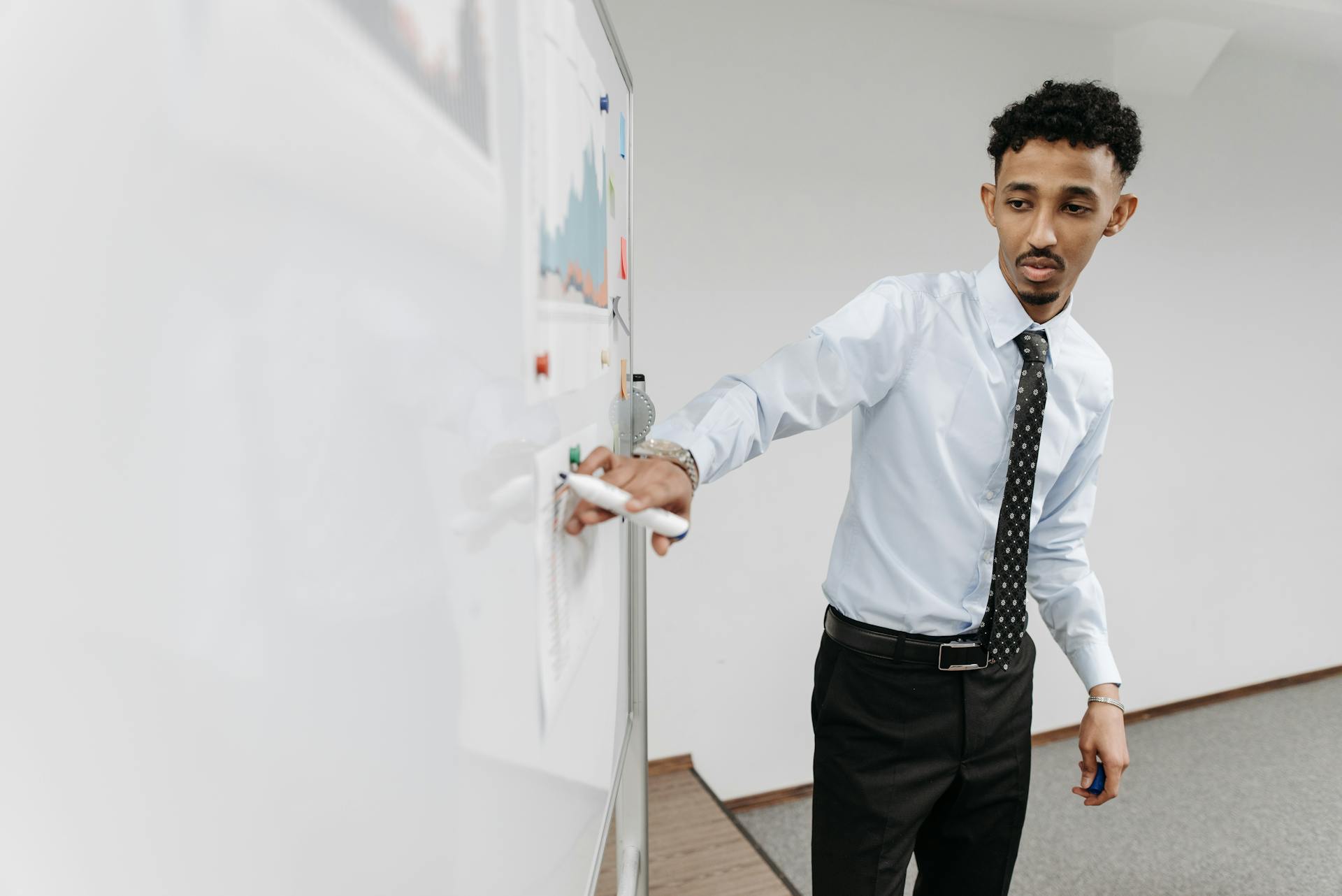 Man Presenting on Whiteboard at Office