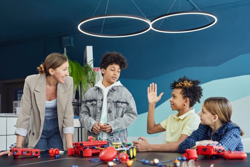 Teacher and students learning about electronics together
