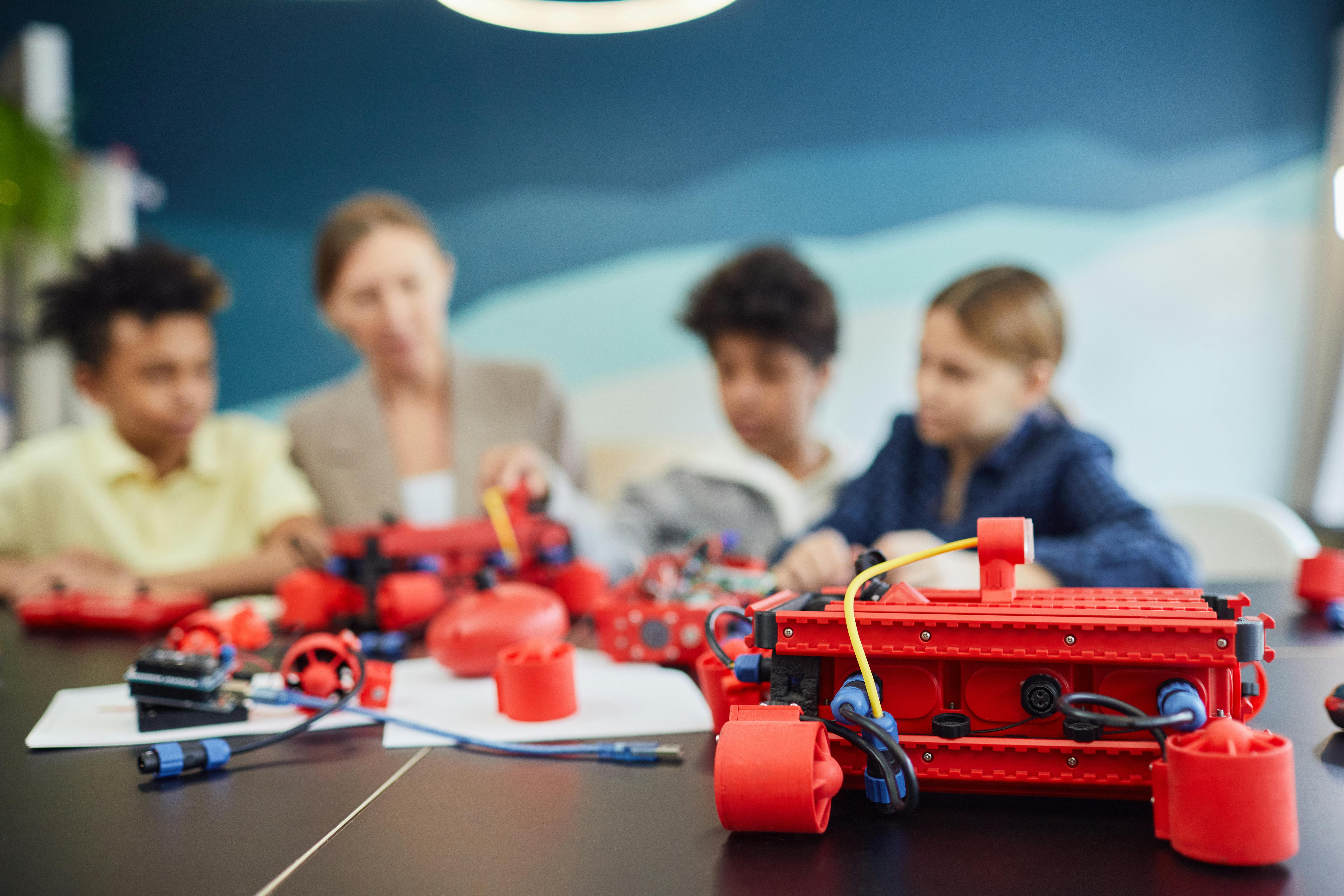 Group of kids working on robotics project, engaging in STEM education.