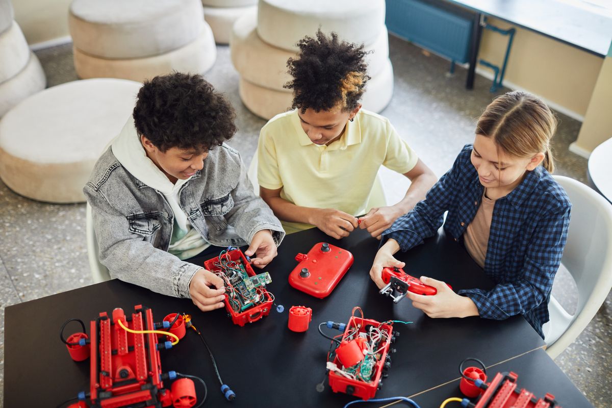 Students learning electronics with toys in a classroom