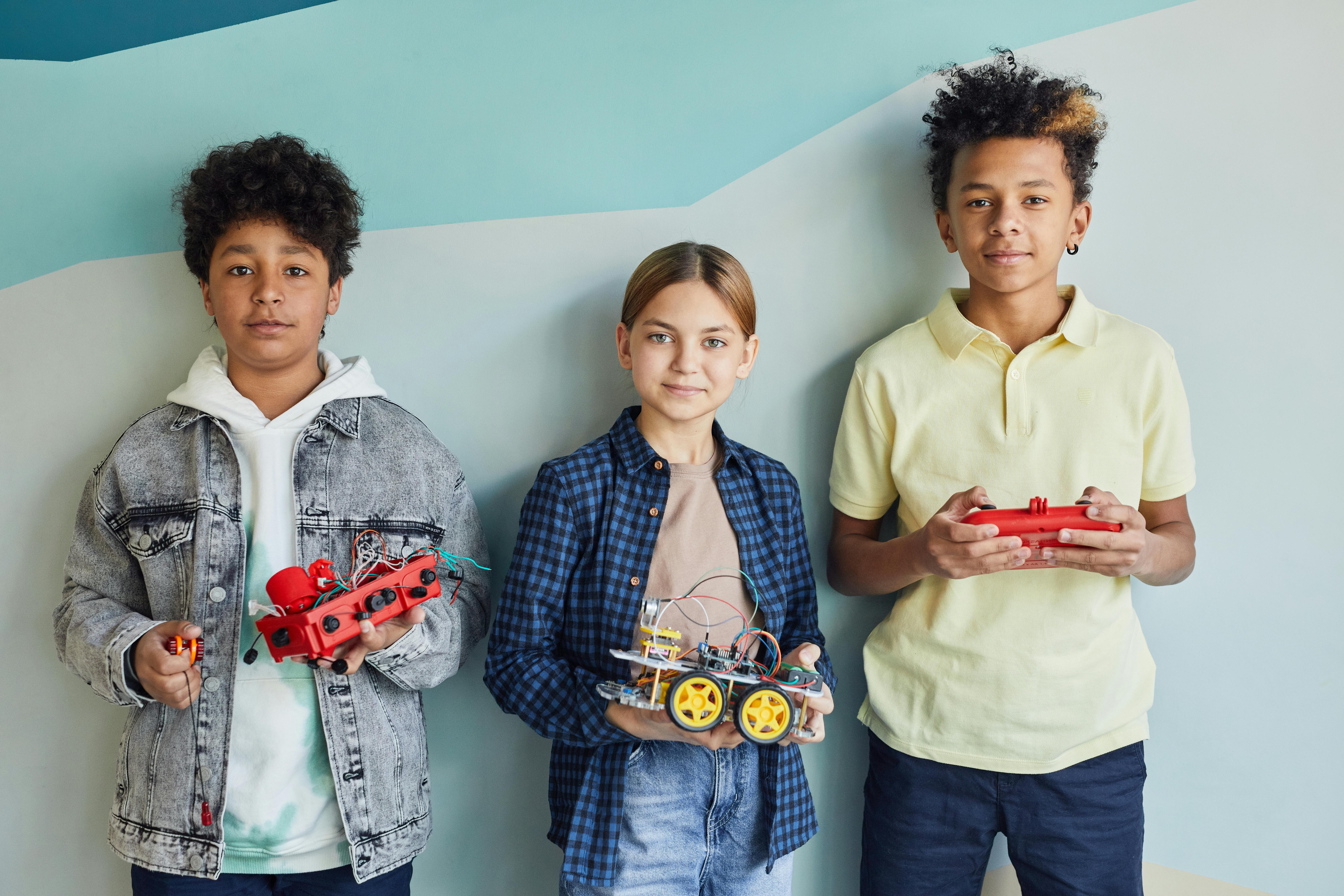 boy in yellow shirt holding red game controller