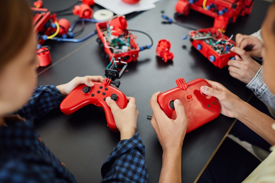 Remote Control Activity Persons Holding a Red and Black Remote Controllers · Free Stock Photo