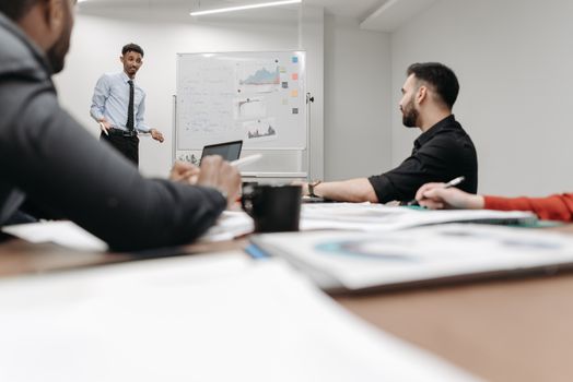 Corporate team during a presentation in an office setting, featuring discussions and planning.