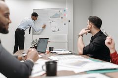Colleagues in a business meeting discussing data and strategies at the office.