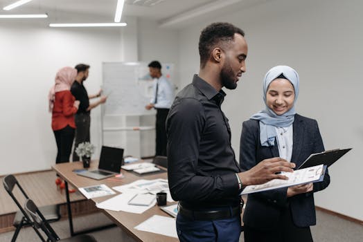 A diverse group of professionals engaged in a collaborative brainstorming session in a well-lit modern office.