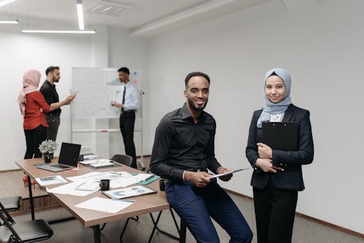 A diverse group of professionals working together in a modern office, focusing on teamwork and collaboration.