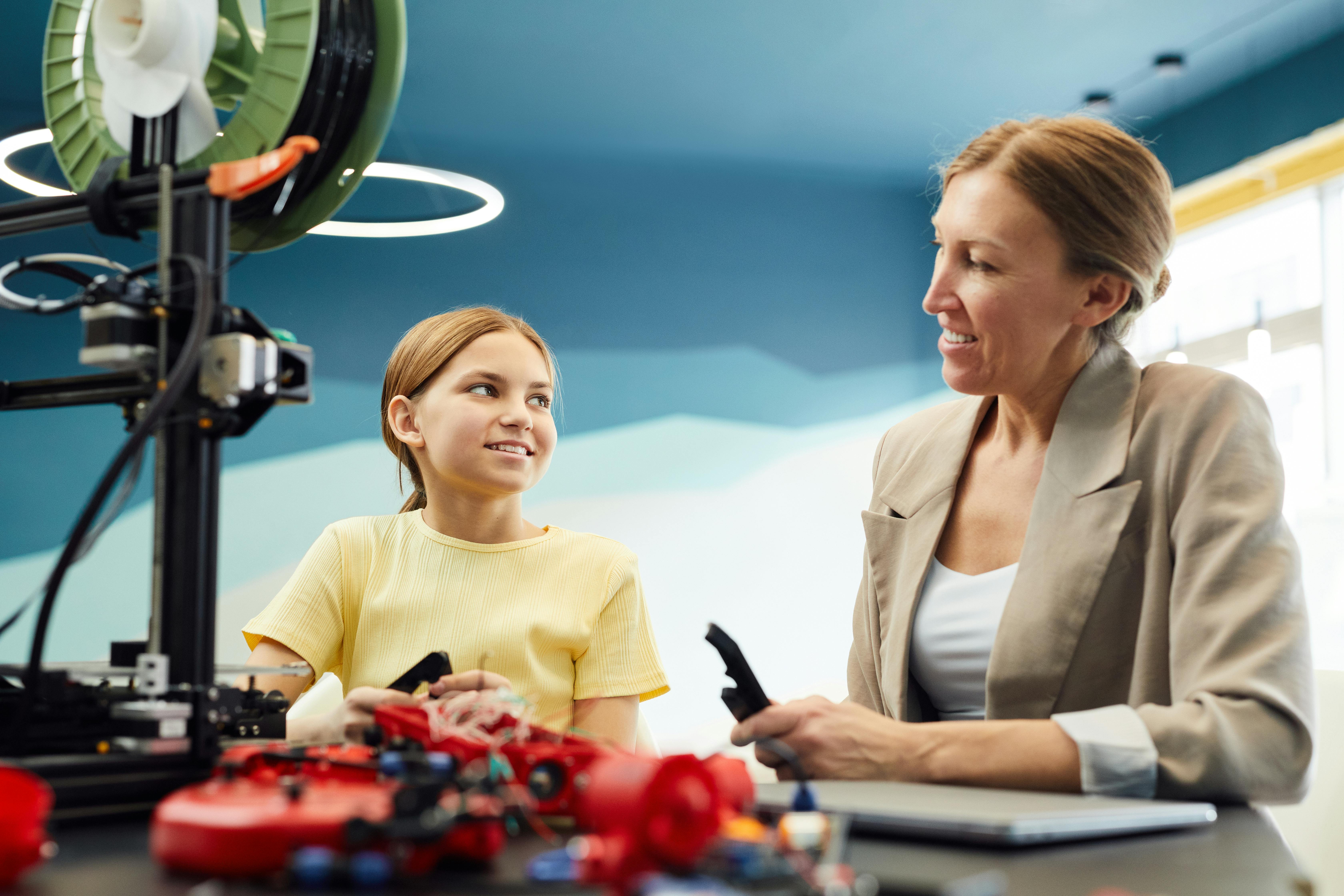 smiling woman and girl working together