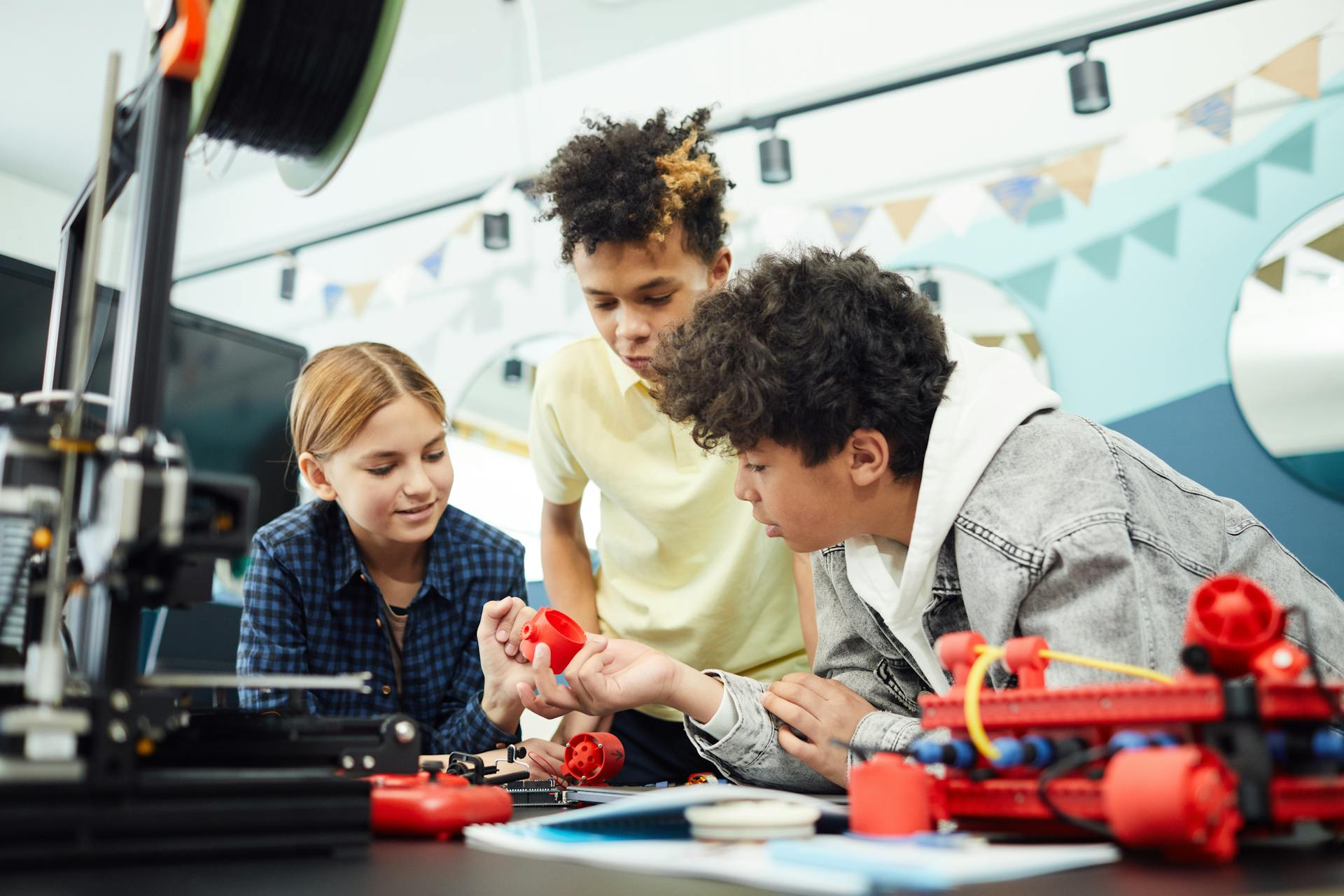 Young students collaborating in a STEM workshop, exploring and learning with innovative tools and devices.