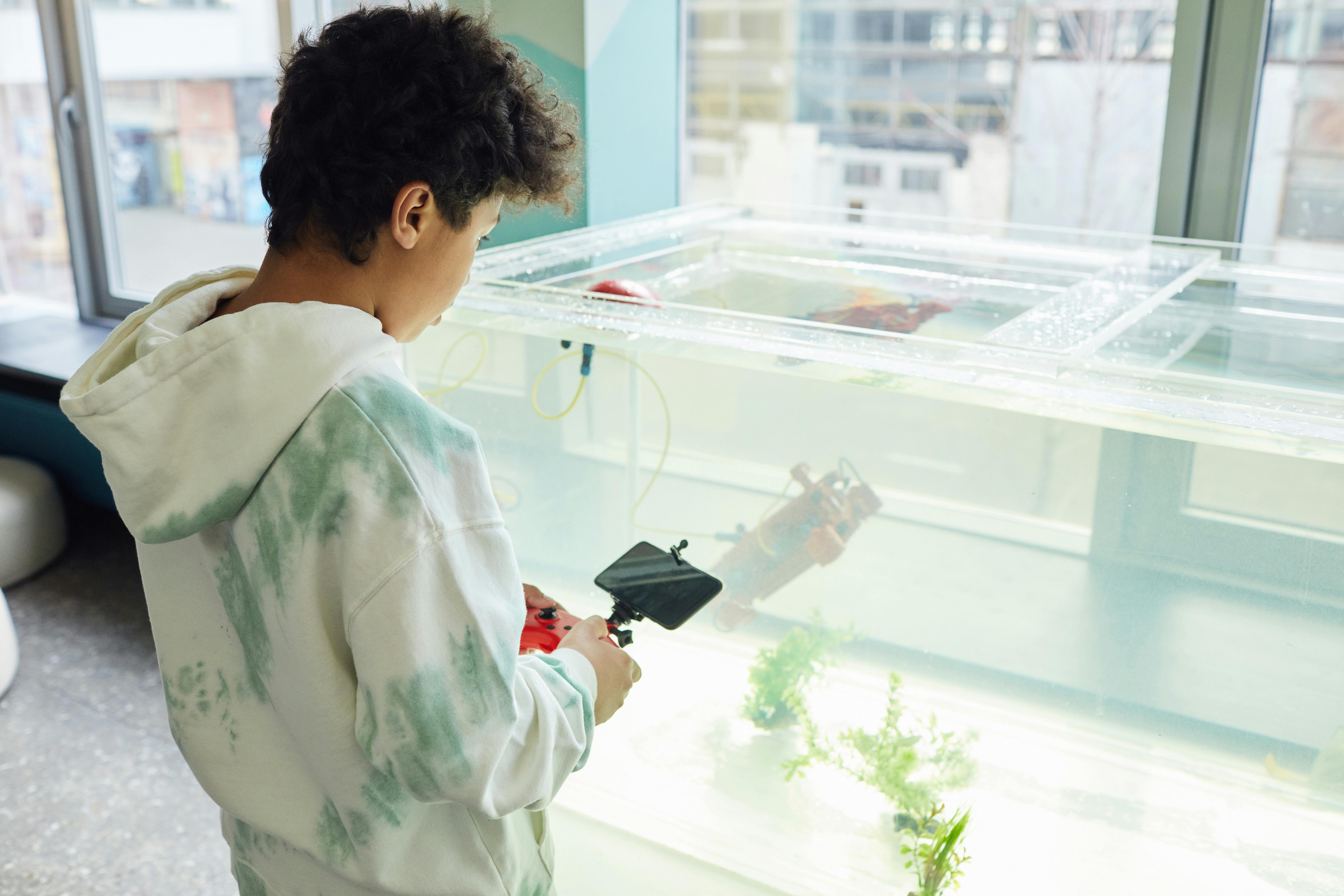 Man in White Dress Shirt Holding Black Smartphone