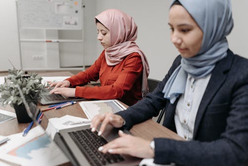 Woman in Gray Blazer and Gray Hijab using Laptop