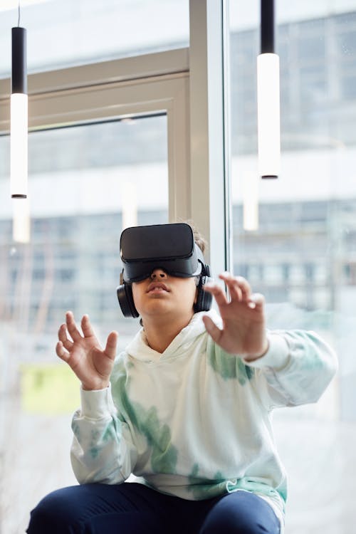 Free Anonymous boy experiencing virtual reality headset Stock Photo