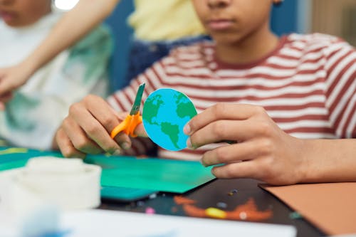 Crop boy making paper craft