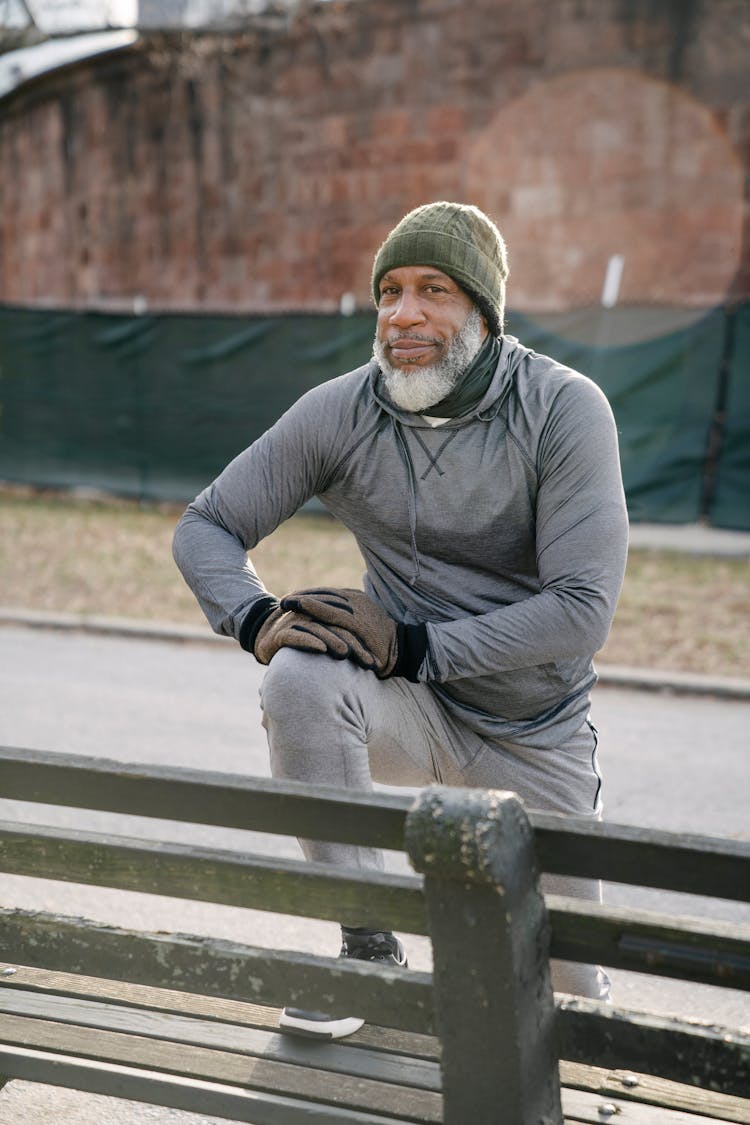 Aged Black Man Warming Up In Park