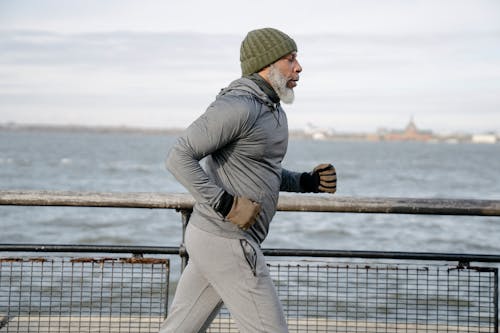 Old black man running near water