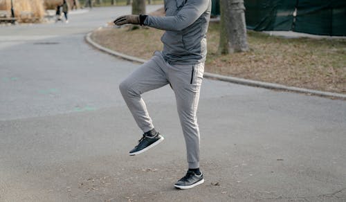 Free Unrecognizable man warming up on street Stock Photo