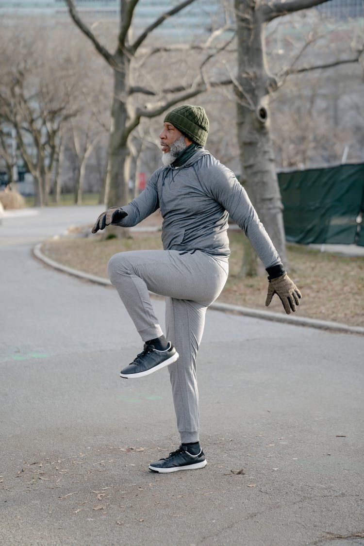 Senior Black Man Warming Up In Park