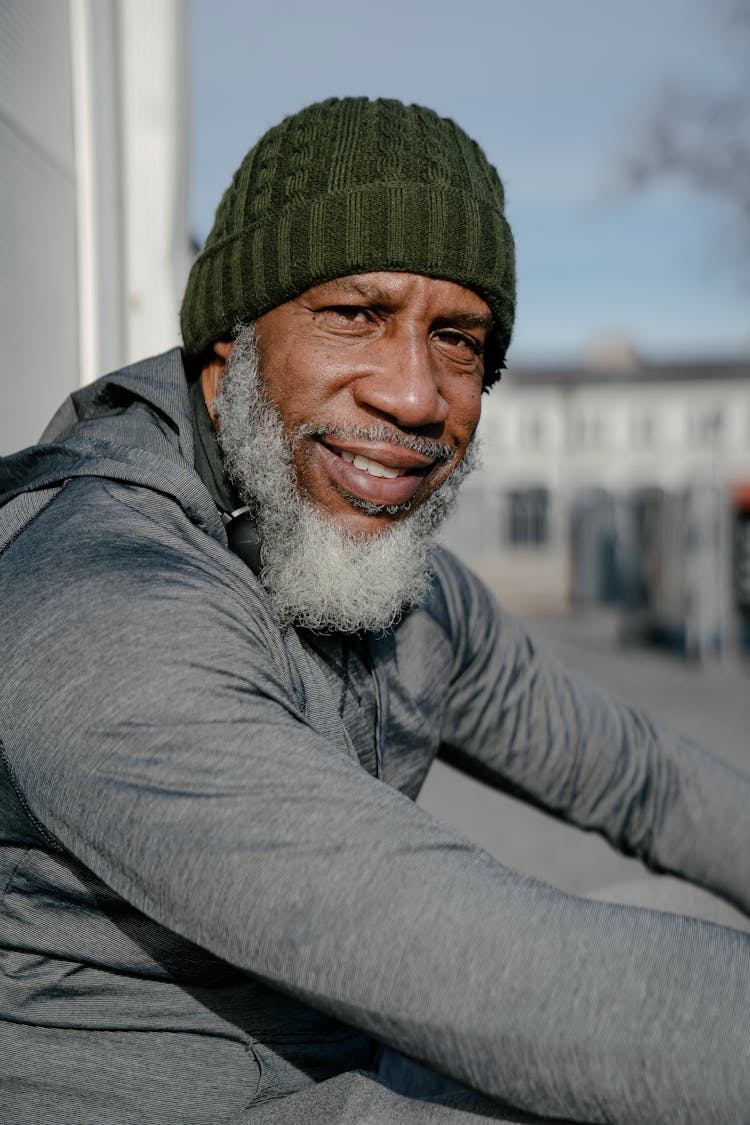 Bearded Black Man In Hat Looking At Camera In Street