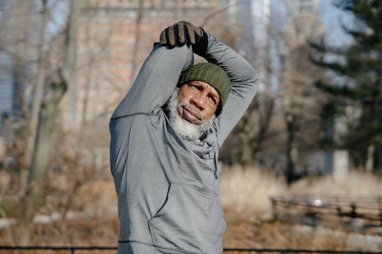 Senior Black Male Doing Exercise In Park In Fall