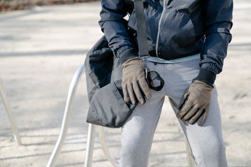 Free Crop person in warm clothes with bag on street Stock Photo