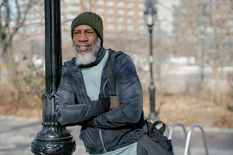 Smiling Black Senior Man In Sportswear Standing Outside