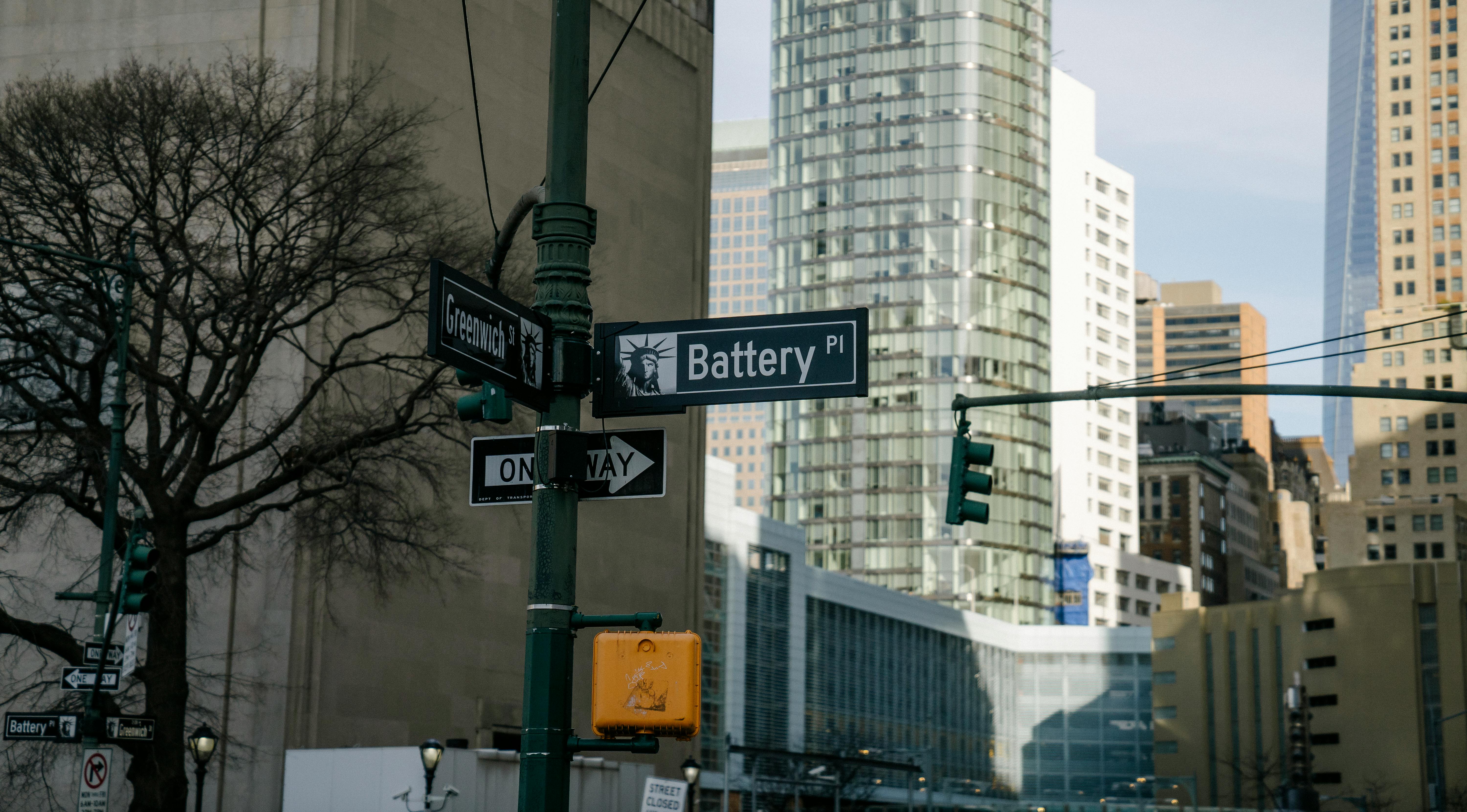 traffic lights and street signs near skyscrapers